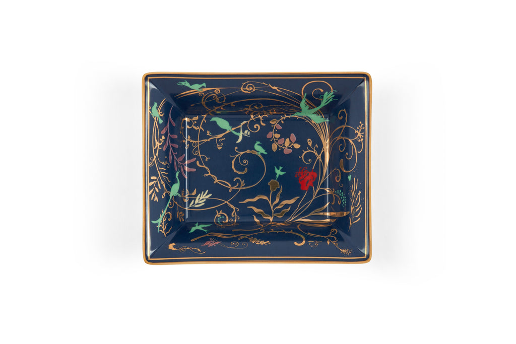 Refined porcelain tray with shimmering gold edges, ideal for showcasing candles or jewelry.