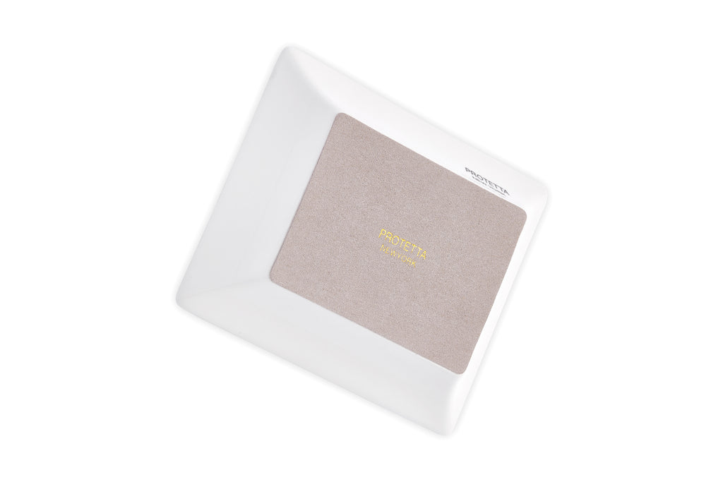 base of A miniature masterpiece, Sleek porcelain tray with rich gold borders, perfect for enhancing any room’s decor.